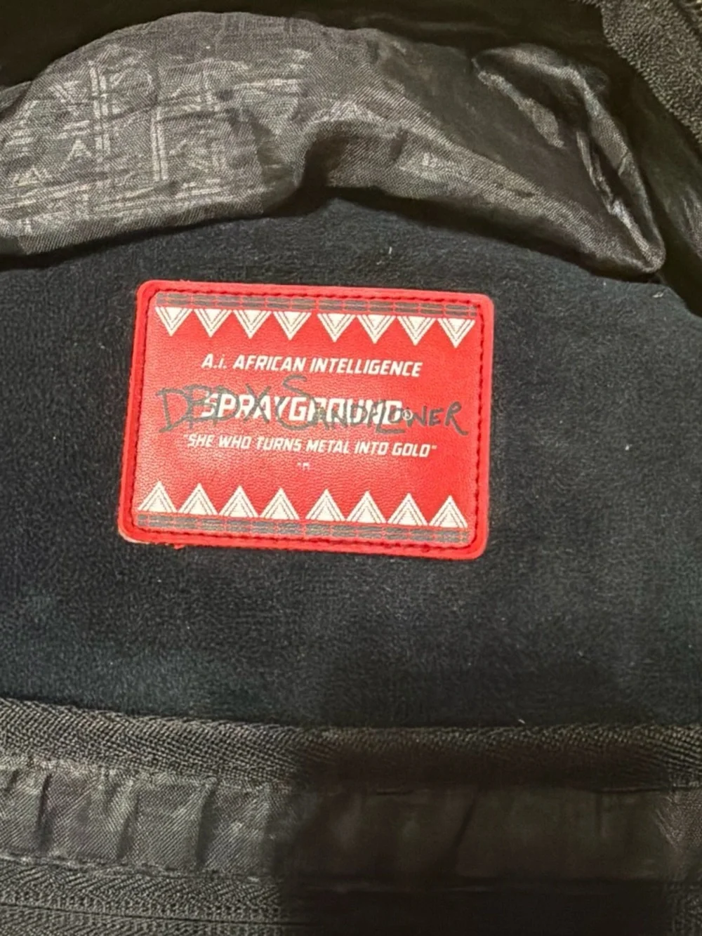 Sprayground Black Backpack with Metallic Gold Tribal Pattern